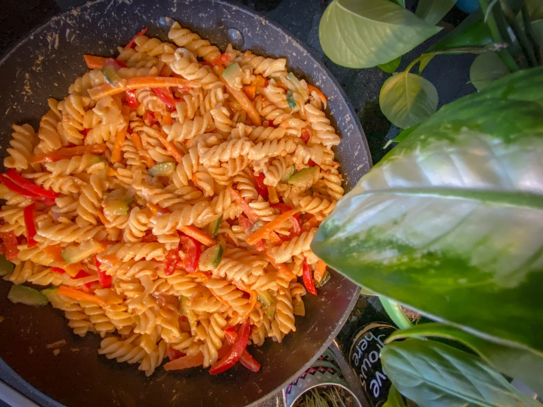 A bowl of vegan peanut butter pasta with vegetables