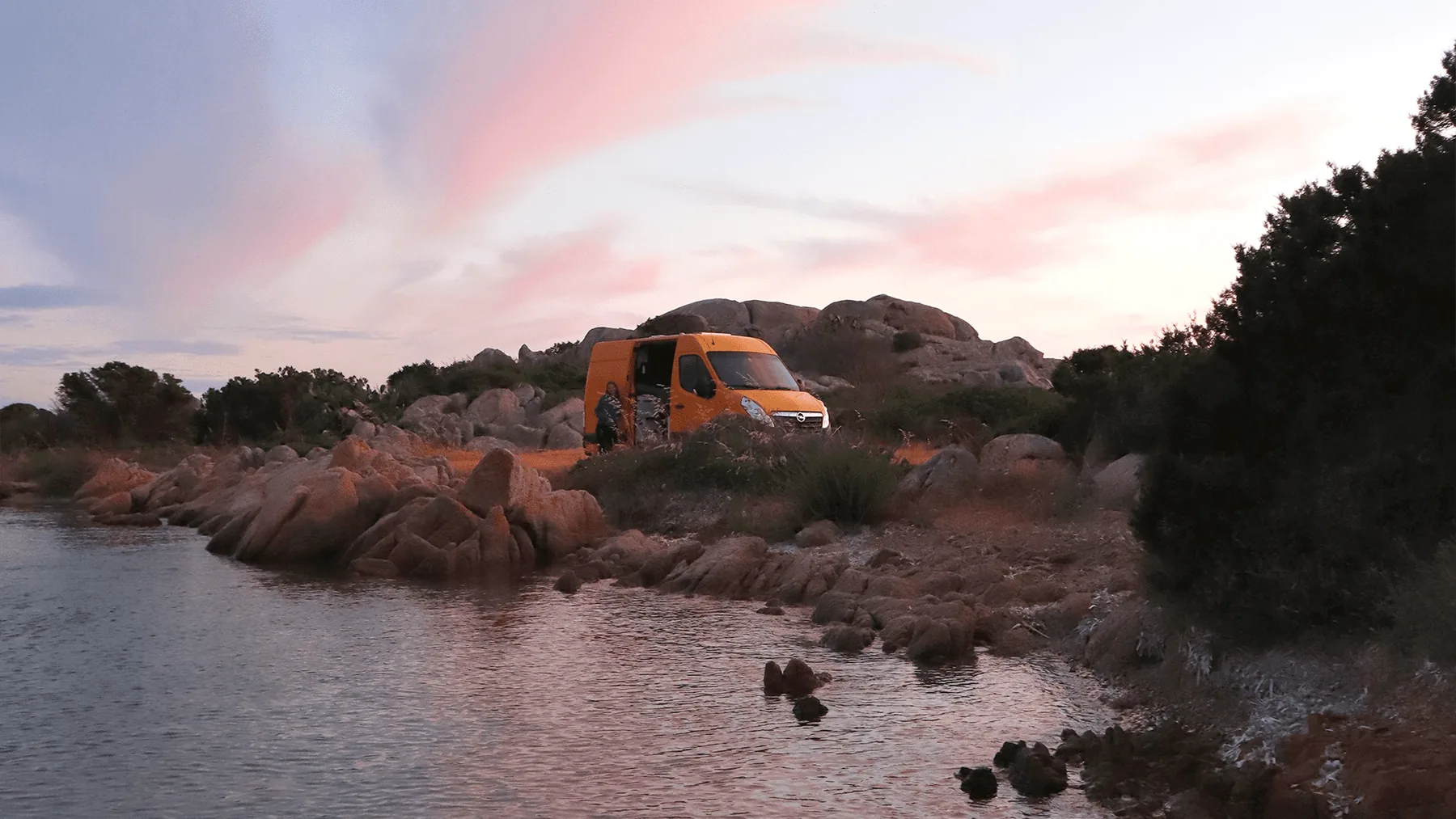 The Bumblebee camper van parked beside a coastal road in Sardinia